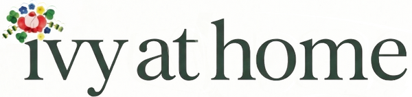 Logo of 'Ivy at Home' with decorative elements on a white background